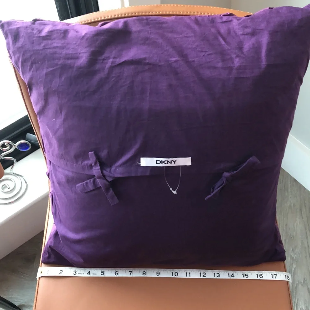 DKNY 18” square pillow. Dark purple pillow case with feather pillow included.